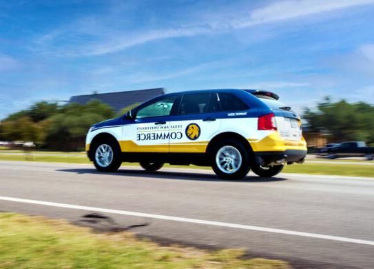 University car with logo and Texas A&M University-Commerce on the side.